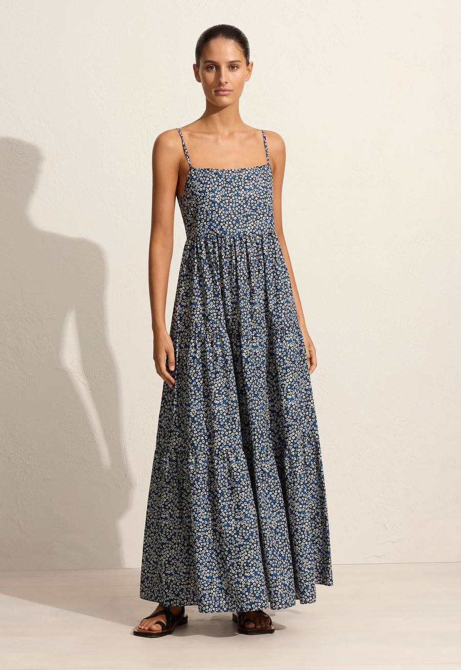This sundress features delicate straps, functional side pockets, and a low scooped back.
