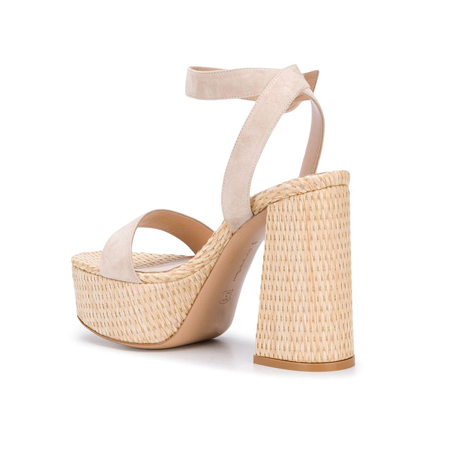 The 'Zandra' here features a raffia platform sole, paired with soft neutral suede. The maxi platform block heel has an ever-so-slight flare to its shape, that holds tribute to iconic 1970's fashion. 
