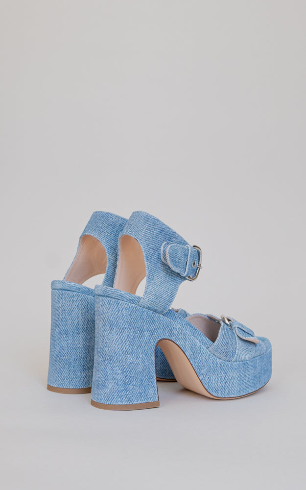A 60s-inspired, clog style heel. Constructed on a wooden clog, the denim effect printed leather also covers the platform and heel. 