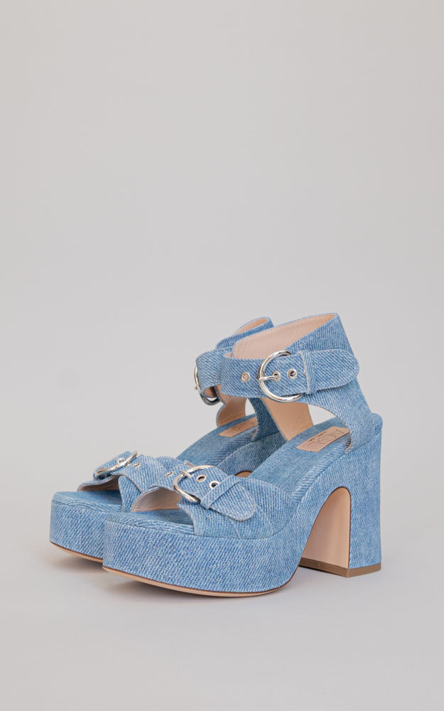 A 60s-inspired, clog style heel. Constructed on a wooden clog, the denim effect printed leather also covers the platform and heel. 