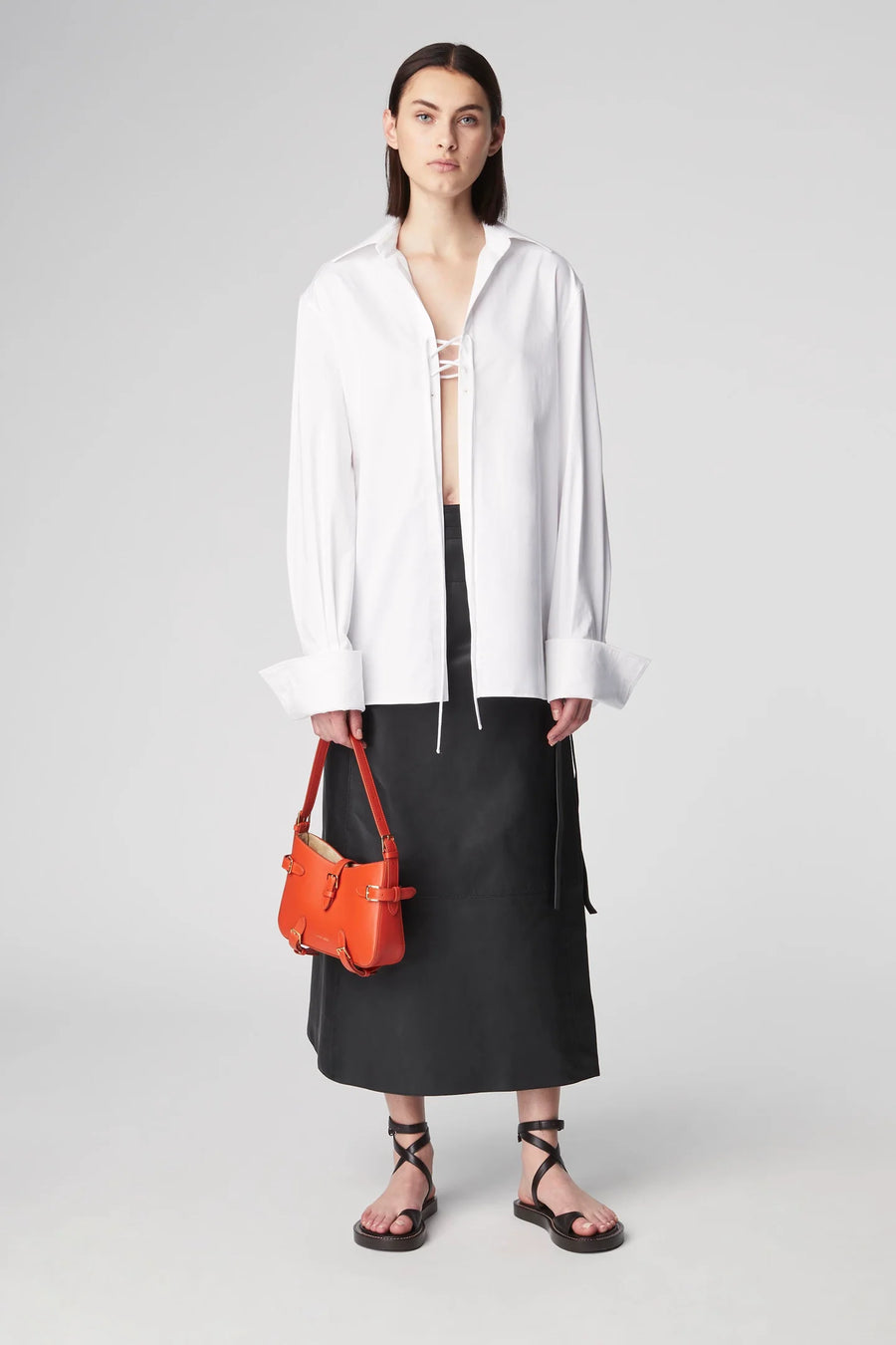 Oversized blouse featuring tie detailing at the chest and a wide collar. 
