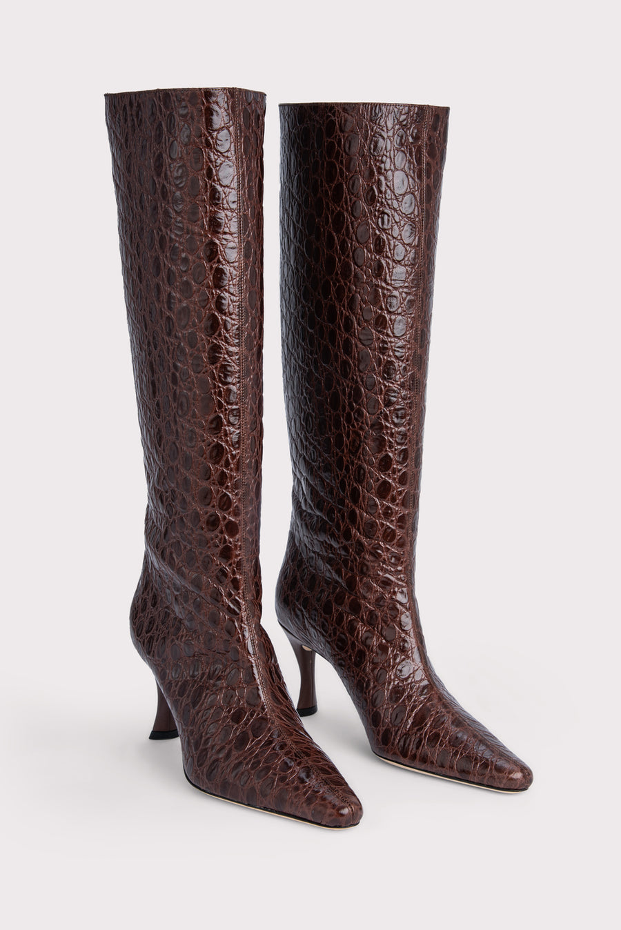 The 'Stevie' 42 are the ultimate shaft boot for this season. Made with a croc-embossed leather, they finish below the knee adding a vintage vibe and slope into a pointed toe, set on an angular heel. Pair with a midi dress for a bohemian look. 