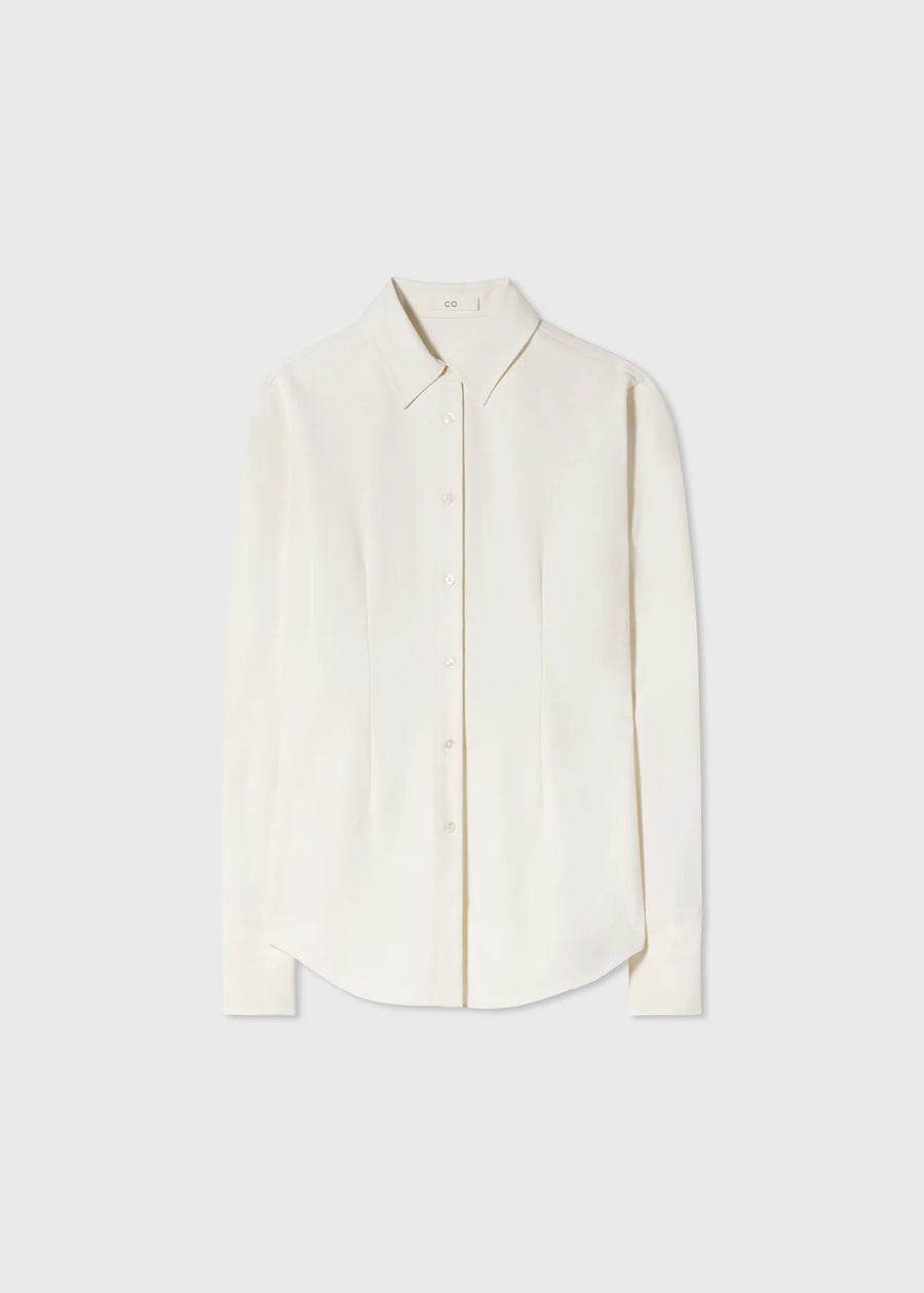 Classic long sleeve button down blouse. Featuring blouson sleeves, darts, french cuffs, and shell buttons.