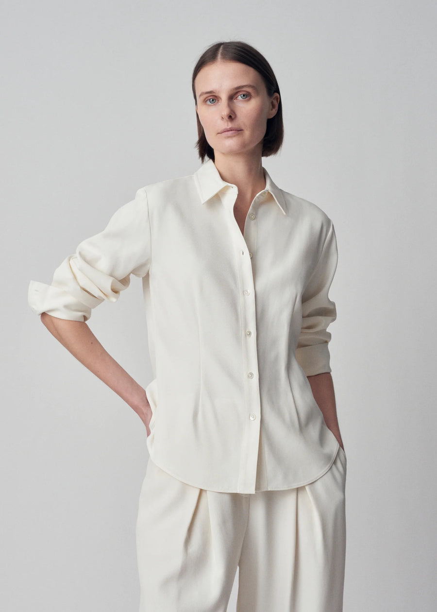 Classic long sleeve button down blouse. Featuring blouson sleeves, darts, french cuffs, and shell buttons.