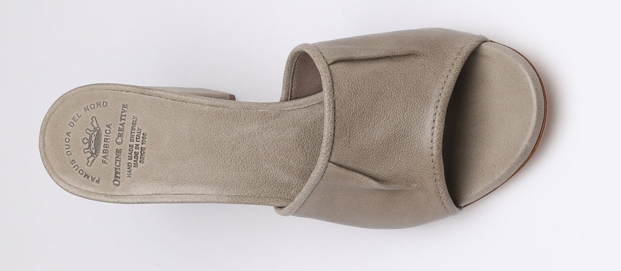With a slightly nostalgic feeling, this mule features a block heel and seaming details across the front panel. Pair the 'Emilie' with a slip skirt and a seamless tank.