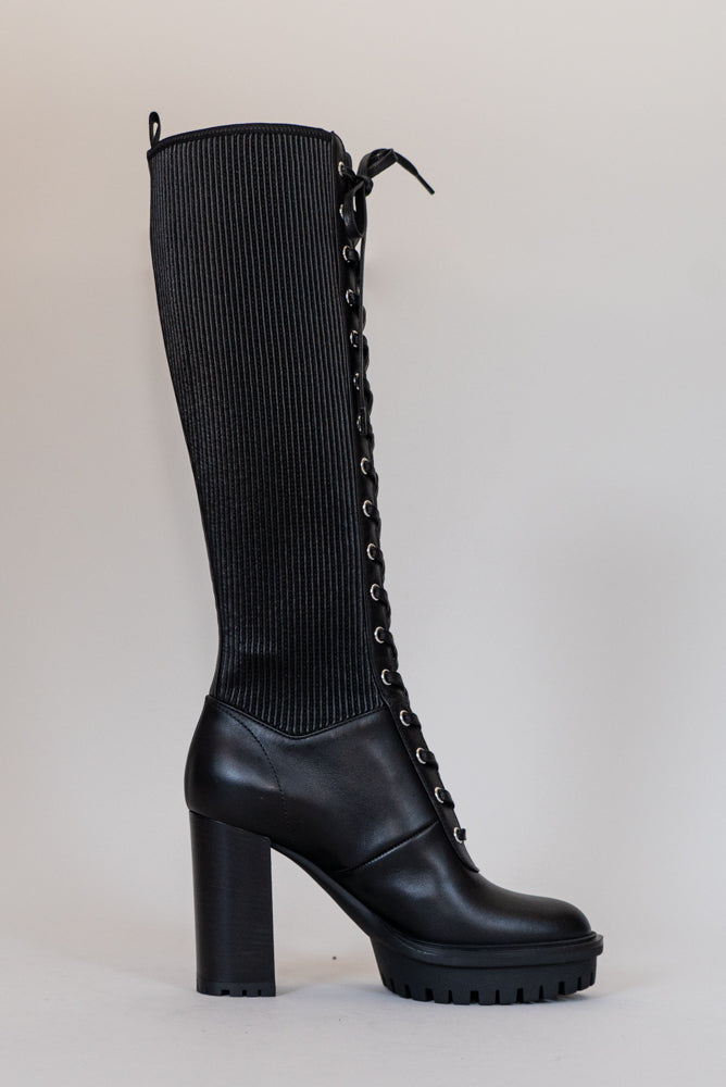 Made from black calf leather, the Martis High Knee Platform Boot features a combat sole that makes it trendy and practical. Perfect for facing any weather condition in style.