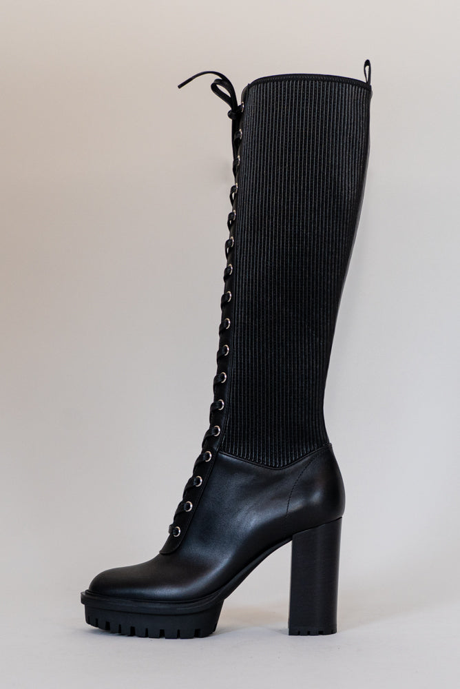 Made from black calf leather, the Martis High Knee Platform Boot features a combat sole that makes it trendy and practical. Perfect for facing any weather condition in style.