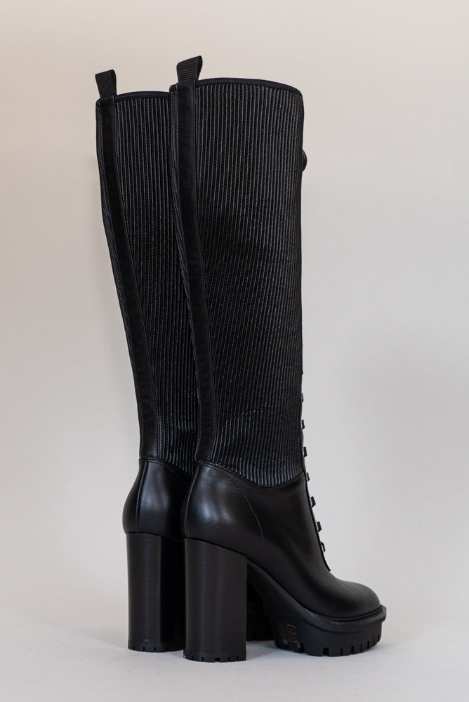 Made from black calf leather, the Martis High Knee Platform Boot features a combat sole that makes it trendy and practical. Perfect for facing any weather condition in style.