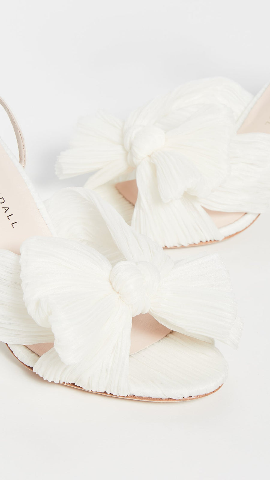The 'Camilla' quickly adds a feminine touch to any look. These sandals are finished in crinkly, ivory taffeta with charming bows. 