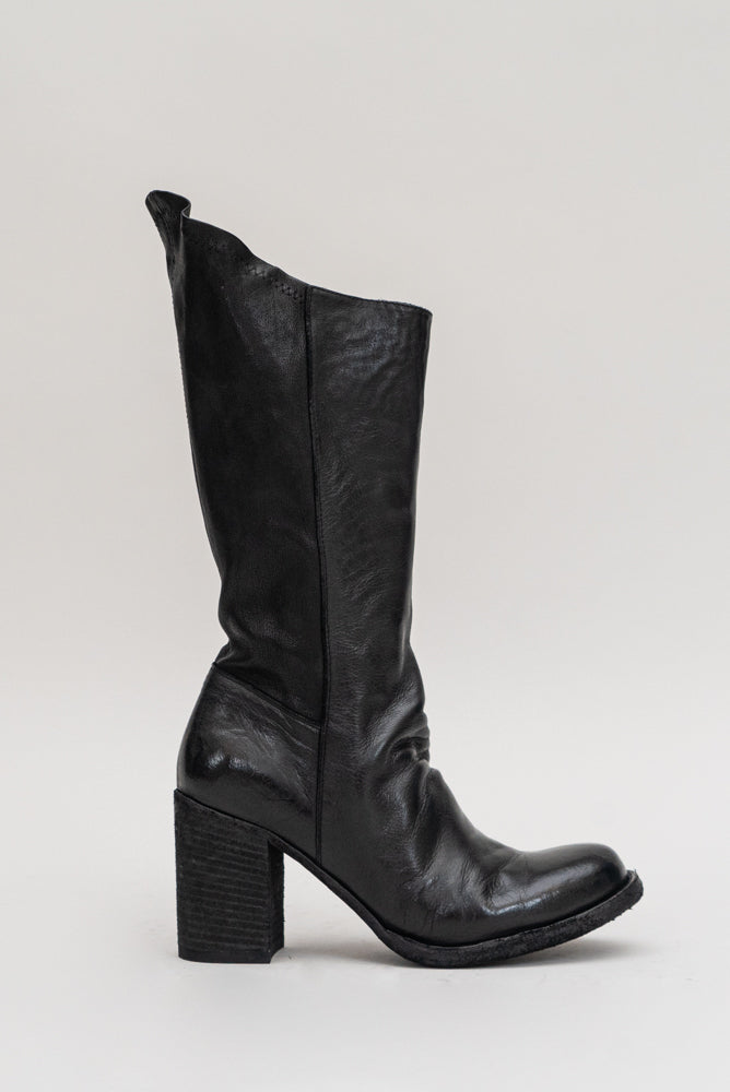 The 'Vernon' stacked leather heel boot is a mid-knee style, and has a side zipper for easy closure. This boot adds a flare to a classic black leather heeled boot. 