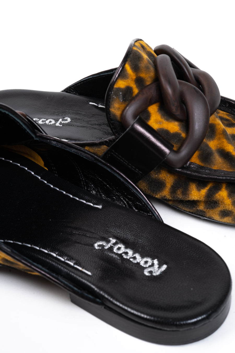 A chic leather slip-on with leopard print, and enamel chain details.